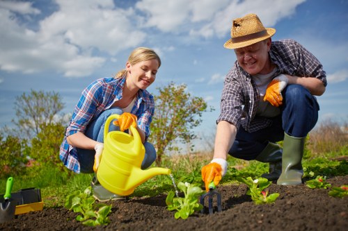 Gardener lifting equipment safely during maintenance